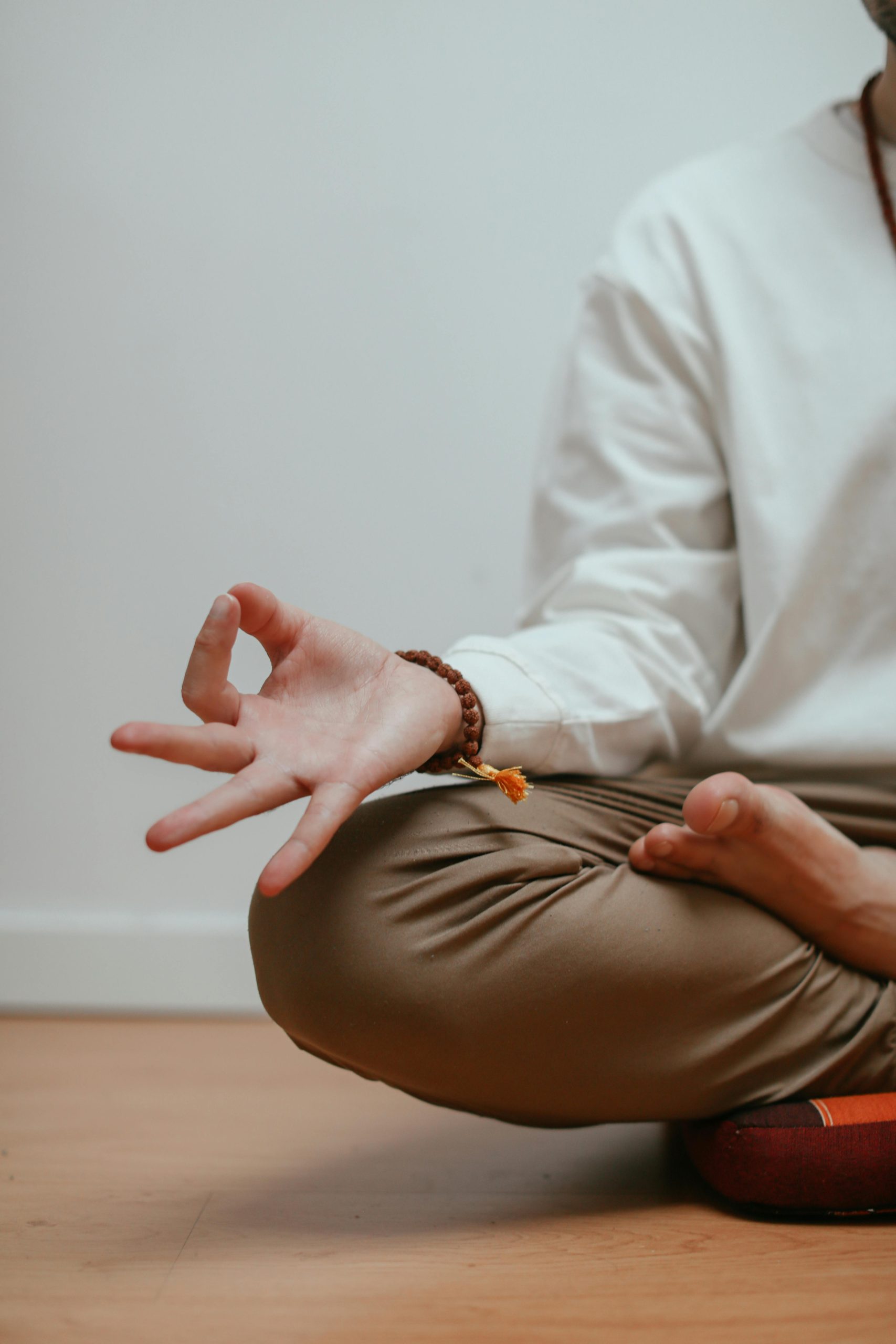 Close-up of a man meditating in a yoga pose, focusing on relaxation and mindfulness.